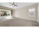 Bright bedroom with carpet flooring and sliding glass door to patio at 2067 Bliss Corner St, Henderson, NV 89044