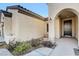 Front entry with arched entryway and dark brown door at 2067 Bliss Corner St, Henderson, NV 89044