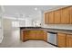 Kitchen with wood cabinets, granite counters, and stainless steel appliances at 2067 Bliss Corner St, Henderson, NV 89044