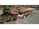 Single-story home with a tile roof, palm trees, and a gravel driveway at 2221 E Winery Rd, Pahrump, NV 89048