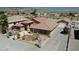 Single-story home with tile roof and landscaped yard, mountain view in background at 2221 E Winery Rd, Pahrump, NV 89048