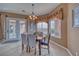 Cozy dining room with natural light, elegant chandelier, and direct access to outdoor area at 2221 E Winery Rd, Pahrump, NV 89048