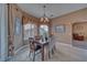 Inviting dining area featuring stylish window treatments, a modern chandelier, and views to the outdoors at 2221 E Winery Rd, Pahrump, NV 89048