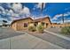 Tan single story home with desert landscaping and a gravel driveway at 2221 E Winery Rd, Pahrump, NV 89048