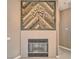 Fireplace with a rustic wood accent wall and metal leaf decoration at 2221 E Winery Rd, Pahrump, NV 89048