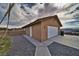 Exterior shot of the garage, showcasing its gravel surrounding at 2221 E Winery Rd, Pahrump, NV 89048