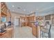 Spacious kitchen with wood cabinets and granite countertops, open to living area at 2221 E Winery Rd, Pahrump, NV 89048