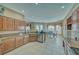 Well-lit kitchen with classic wood cabinetry and stainless steel dishwasher with view of dining area at 2221 E Winery Rd, Pahrump, NV 89048