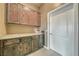 Laundry room with wood cabinets and granite countertop at 2221 E Winery Rd, Pahrump, NV 89048