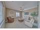 Comfortable living room with neutral tones, a ceiling fan, a large window and plush seating, creating a relaxing space at 2221 E Winery Rd, Pahrump, NV 89048