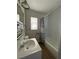 Clean bathroom with a tub, shower, and striped curtain at 2410 Poplar Ave, Las Vegas, NV 89101