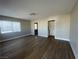 Spacious living room with wood-look flooring and neutral walls at 2410 Poplar Ave, Las Vegas, NV 89101