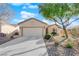 Single-story house with a two-car garage and nicely landscaped yard at 2525 Shore Bird Ave, North Las Vegas, NV 89084