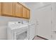 Laundry room with washer, dryer, and overhead cabinets at 2525 Shore Bird Ave, North Las Vegas, NV 89084