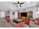 Bright living room with hardwood floors, comfortable seating, and a large TV at 2525 Shore Bird Ave, North Las Vegas, NV 89084