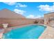 Refreshing pool with a water feature and surrounding landscaping at 2525 Shore Bird Ave, North Las Vegas, NV 89084