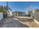 Large backyard with dirt and a covered patio at 2620 Shiloh Way, North Las Vegas, NV 89030