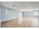 Living room with tile floors and neutral walls and large windows at 2620 Shiloh Way, North Las Vegas, NV 89030