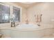 Elegant bathroom featuring a soaking tub and decorative window at 2777 Paradise Rd # 3701, Las Vegas, NV 89109