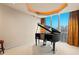 Music room with grand piano and city views at 2777 Paradise Rd # 3701, Las Vegas, NV 89109