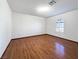 Bright bedroom featuring hardwood floors and arched window at 311 E Desert Rose Dr, Henderson, NV 89015