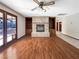 Gathering room with fireplace, built-in shelving, and hardwood floors at 311 E Desert Rose Dr, Henderson, NV 89015