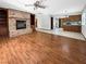 Living room with fireplace, hardwood floors, and kitchen access at 311 E Desert Rose Dr, Henderson, NV 89015