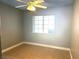 This bedroom features tile floors, a ceiling fan, and a window for natural light at 3155 Mountain Spring Rd, Las Vegas, NV 89146