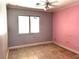 Bedroom featuring a large window, pink accent wall, and tile flooring at 3155 Mountain Spring Rd, Las Vegas, NV 89146