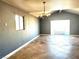 Open-concept living room with tile flooring and an elegant chandelier at 3155 Mountain Spring Rd, Las Vegas, NV 89146