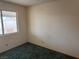 Bedroom with teal carpet and a window overlooking the backyard at 3160 James A Bilbray Pkwy, Laughlin, NV 89029