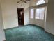 Bright dining room with teal carpet and access to the kitchen at 3160 James A Bilbray Pkwy, Laughlin, NV 89029