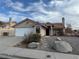 Single-story house with a two-car garage and landscaped front yard at 3160 James A Bilbray Pkwy, Laughlin, NV 89029