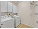 Bright laundry room with washer, dryer and storage at 33 Gentilly Lace Ave, Henderson, NV 89002