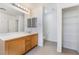 Bright bathroom featuring vanity, toilet, and separate shelving unit for storage at 3517 Colby Creek Ave, North Las Vegas, NV 89081