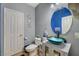 Bathroom with teal vessel sink, white vanity, and blue walls at 3517 Colby Creek Ave, North Las Vegas, NV 89081