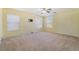 Bedroom with carpet, two windows and ceiling fan with a neutral color scheme at 3517 Colby Creek Ave, North Las Vegas, NV 89081