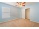 Light blue bedroom with a ceiling fan, window, and closet at 3517 Colby Creek Ave, North Las Vegas, NV 89081