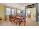 Formal dining room with a large wood table and eight chairs at 3517 Colby Creek Ave, North Las Vegas, NV 89081