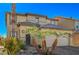 Tan two-story house with palm trees and a paved driveway at 3517 Colby Creek Ave, North Las Vegas, NV 89081