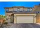 Two-story house with tan siding, brown roof, and a two-car garage at 3517 Colby Creek Ave, North Las Vegas, NV 89081