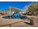 Community playground with shaded play structure and multiple slides at 3517 Colby Creek Ave, North Las Vegas, NV 89081