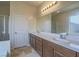 Double vanity bathroom with large mirror and tiled floor at 372 Monique Springs St, Henderson, NV 89014