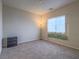 Bright bedroom with carpet, window, and floor lamp at 372 Monique Springs St, Henderson, NV 89014