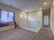 Upstairs hallway with carpet, white railing, and access to bedrooms at 372 Monique Springs St, Henderson, NV 89014