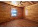 Bright bedroom with wood walls and hardwood floors, showcasing a large window at 3900 W Landberg Ave, Las Vegas, NV 89141