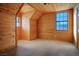 Cozy bedroom with wood walls and carpeted floor, featuring a large window at 3900 W Landberg Ave, Las Vegas, NV 89141