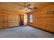 Bedroom with wood walls, ceiling fan, and ensuite bathroom at 3900 W Landberg Ave, Las Vegas, NV 89141