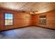 Bedroom with wood walls, ceiling fan, and large windows at 3900 W Landberg Ave, Las Vegas, NV 89141