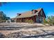 Rustic log home exterior, spacious yard, and desert landscape at 3900 W Landberg Ave, Las Vegas, NV 89141